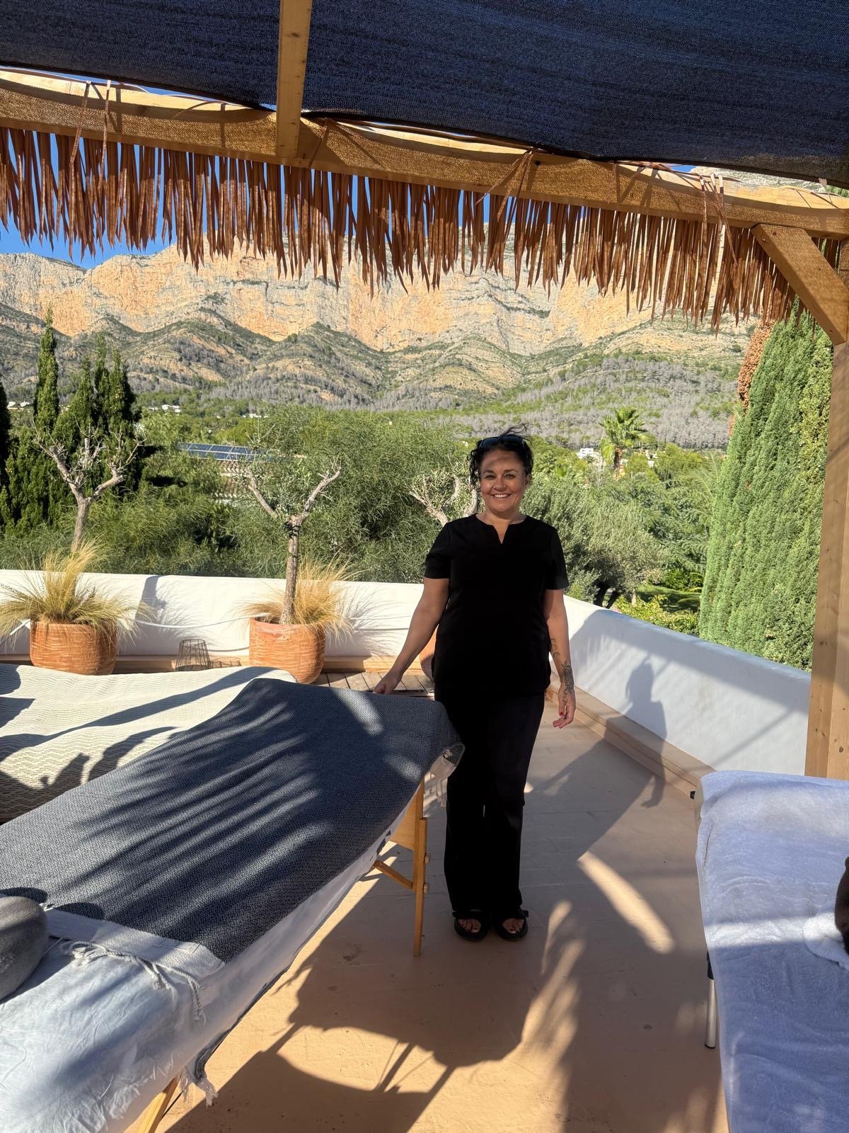 Lisa Blackie with massage tables on a terrace
